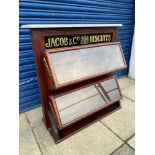 A Jacob & Co'.s Biscuits two tier mahogany serving cabinet, the two tiers with glass fronts and