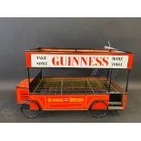 A decorative tin and wirework constructed beer trolley 'bus' with advertising all round for