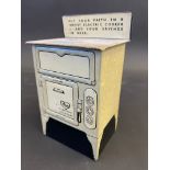 A novelty tinplate money box in the form of and advertising Revo Electric Cookers, 5 1/2" h.