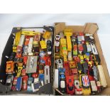 A large quantity in two trays of larger scale die-cast vehicles to include Lesney, Matchbox etc. all