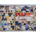 A quantity of matchbooks all with advertising on.