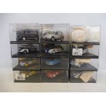 12 die-cast vehicles in display boxes, mainly rally vehicles, various makes.