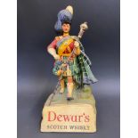 A Dewar's Scotch Whisky advertising figure, 9 1/2" h.