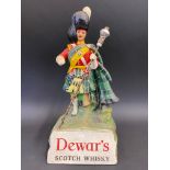 A Dewar's Scotch Whisky advertising figure, 9 1/2" h.