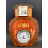 An OXO combined barometer and calendar, in the shape of a jar, 8 1/2 x 12 1/2".