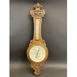 An early 20th Century oak cased barometer with advertising to the dial for Harry Hall Coat