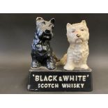 A Buchanan's 'Black & White' Scotch Whisky advertising figure of two dogs, 5 1/2" w.