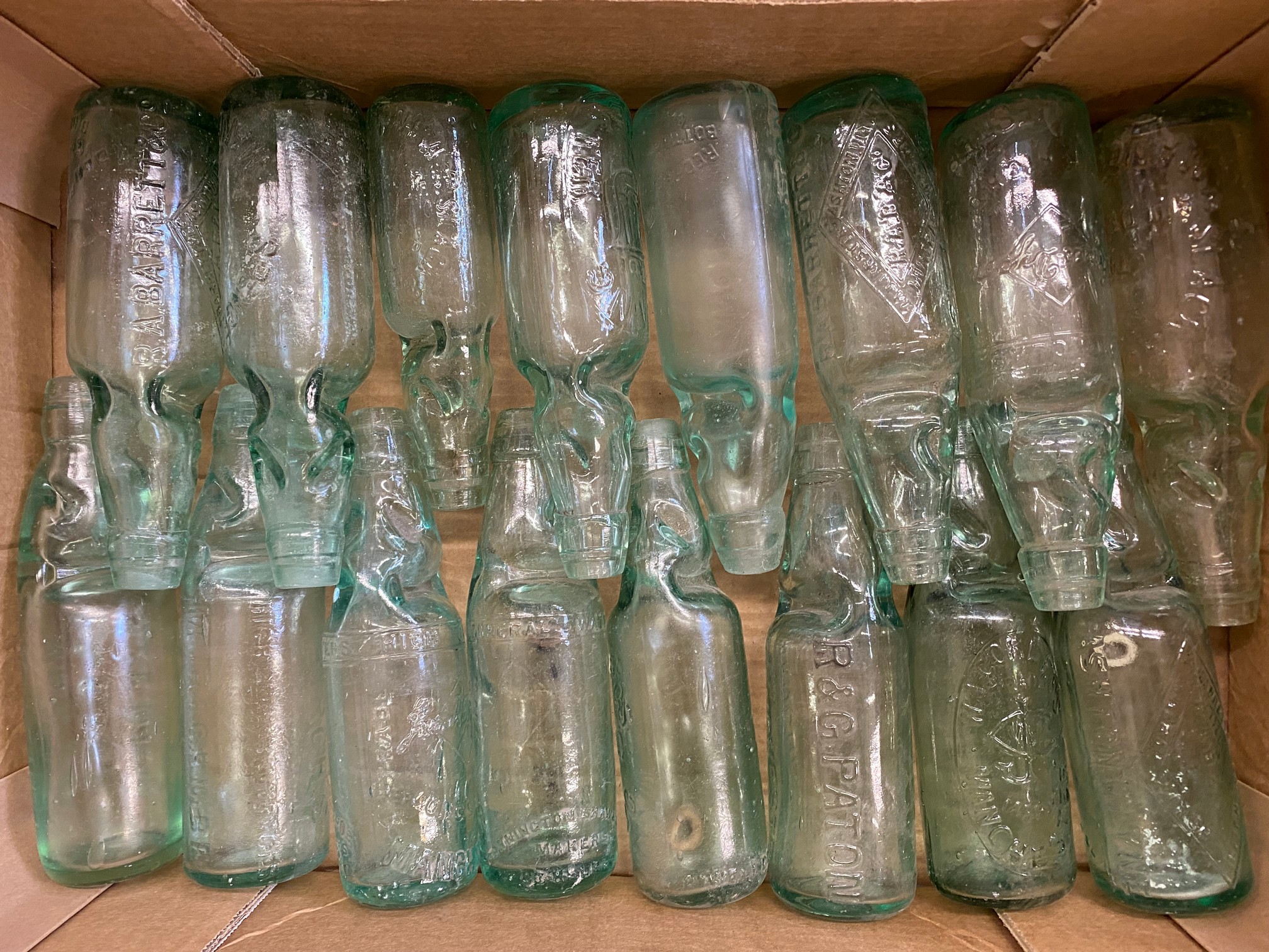 An assortment of glass cod bottles.