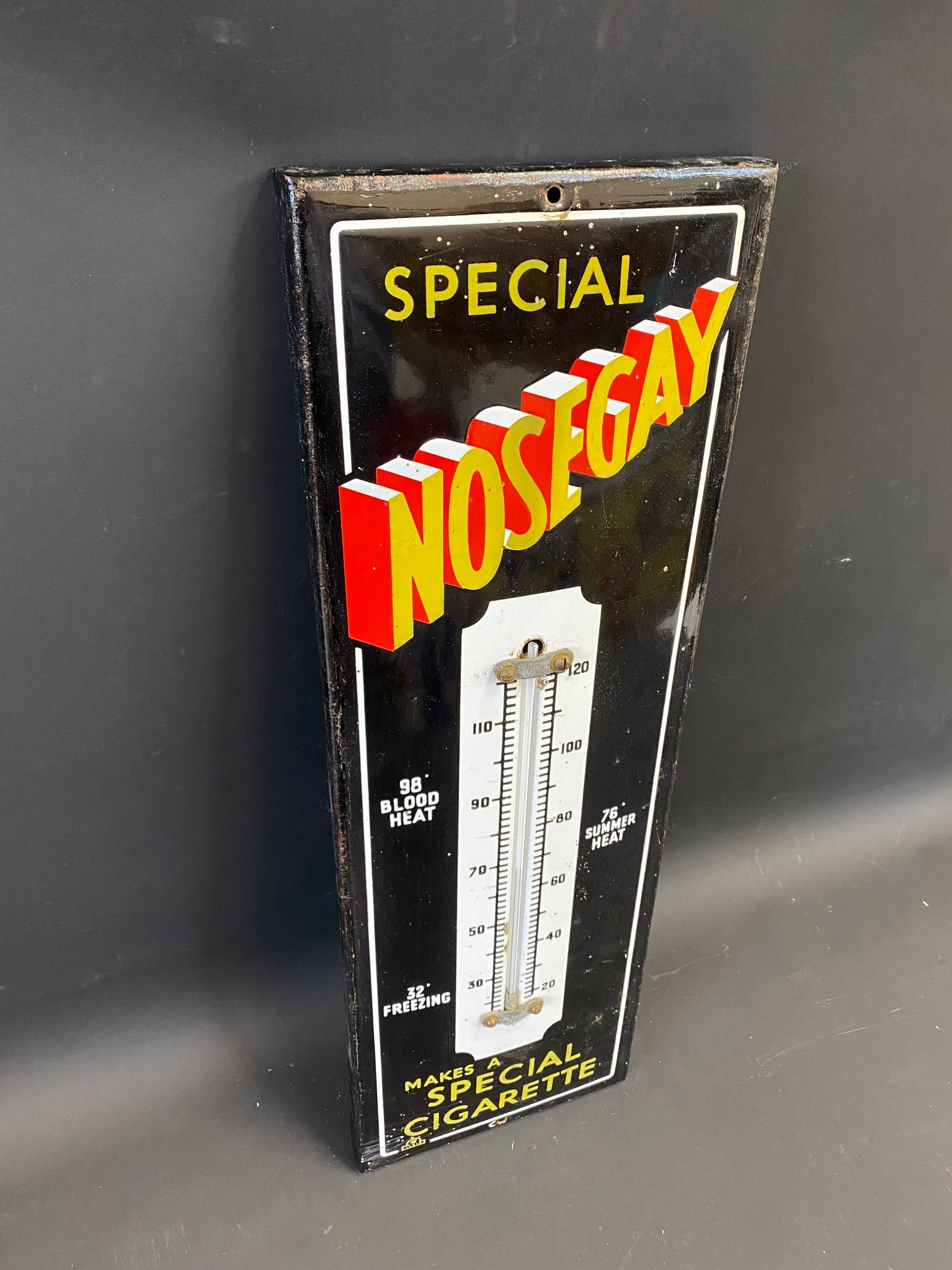 A Nosegay Cigarettes enamel thermometer, 7 1/2 x 22 1/2".