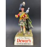 A Dewar's Scotch Whisky advertising figure, 9 1/2" h.