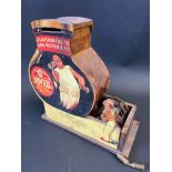 An unusual wooden jar shaped money box with hand-operated mechanism advertising Bovril, 7 1/2"