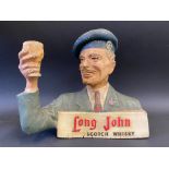 A rare Long John Scotch Whisky ruberoid counter top advertising figure, stamped SPW, 9" w x 8" h.