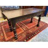 An oak centre table of Elizabethan design with a rectangular top above a carved frieze, on