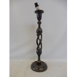 A Kashmir style candlestick with a turned and pierced column, decorated with gilt on a dark blue