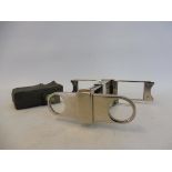 A very good quality silver plated pair of travelling folding binoculars, of skeleton form, by