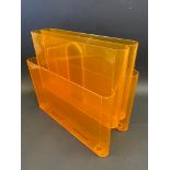 A mid-20th Century stylish orange perspex magazine rack designed by Giotto Stoppino for Kartell,