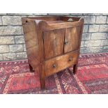 A 19th Century mahogany tray top bedside commode with panelled doors above a drawer