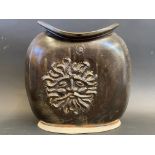 A studio pottery brown glazed vase of flattened shape, each side moulded with a face, with