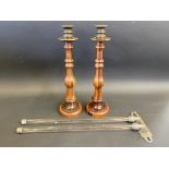 A pair of baluster turned lignum vitae candlesticks with brass sconces and drip pans, 16" high;