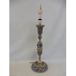 A Kashmir style candlestick decorated with blue flowers and foliage on an ivory ground