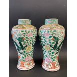 A pair of Chinese famille verte baluster vases decorated with dragons and foliage, 11 1/2" high.