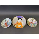 A modern Japanese plate decorated with a geisha; and a pair of plates (3).