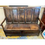 A 17th/18th Century oak box seat settle with fielded panels and a flap seat, 61" w.