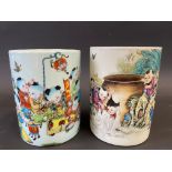 A pair of Chinese cylindrical brush pots decorated with figures of children and caligraphy,