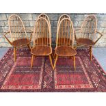 A set of six mid-20th Century Ercol high back dining chairs, two with arms, bearing