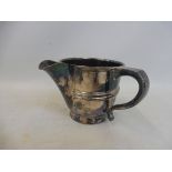 An early 20th Century silver jug with a scrolled side handle, Chester possibly 1915 marked to the