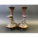 A pair of Japanese bronze vases with slender necks, each applied with a bird on foliage, 5 1/2"