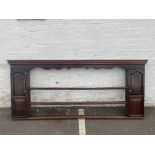 An 18th Century oak delft rack flanked by doors, fitted with shaped and green painted shelves, 92