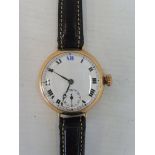A 9ct gold cased wristwatch with a white enamel dial, modern leather strap, approx.