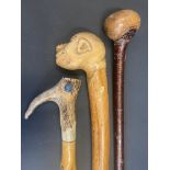 A walking stick with antler handle; and two others (3).