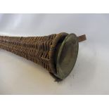 A 19th Century coaching horn, probably Irish, in a wicker case, the horn 37 1/2" long; Provenance