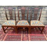 A set of three 18th Century mahogany side chairs, probably Irish, with shaped top rails and