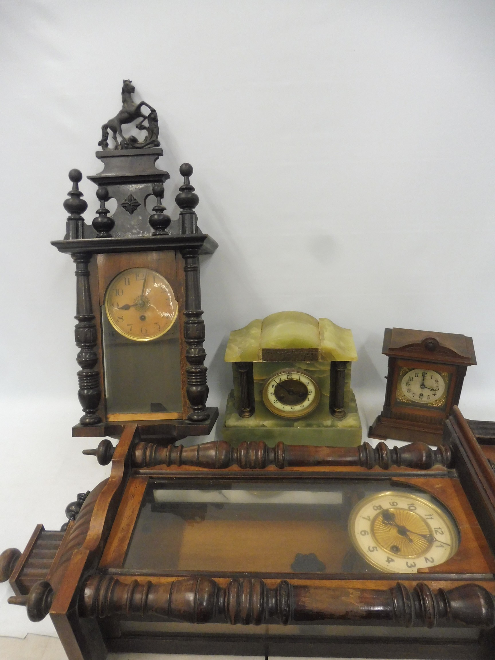 A Vienna-style regulator, a second wall clock plus two mantle clocks.