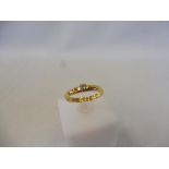 A 22ct gold ring set with a small diamond, size O, approx. 3.0g