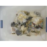 A large box of bagged jewellery from a shop clearance.