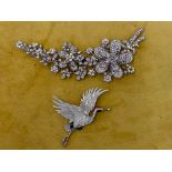Two Butler & Wilson crystal brooches, floral spray h 7cm, w 14.5cm and a flying stork/heron with