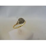 An Edwardian gold ring set with a cluster of diamonds, size L/M, approx. 1.9g.