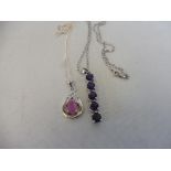 A pink sapphire and silver oval pendant on a silver chain and an amethyst bar pendant on a silver