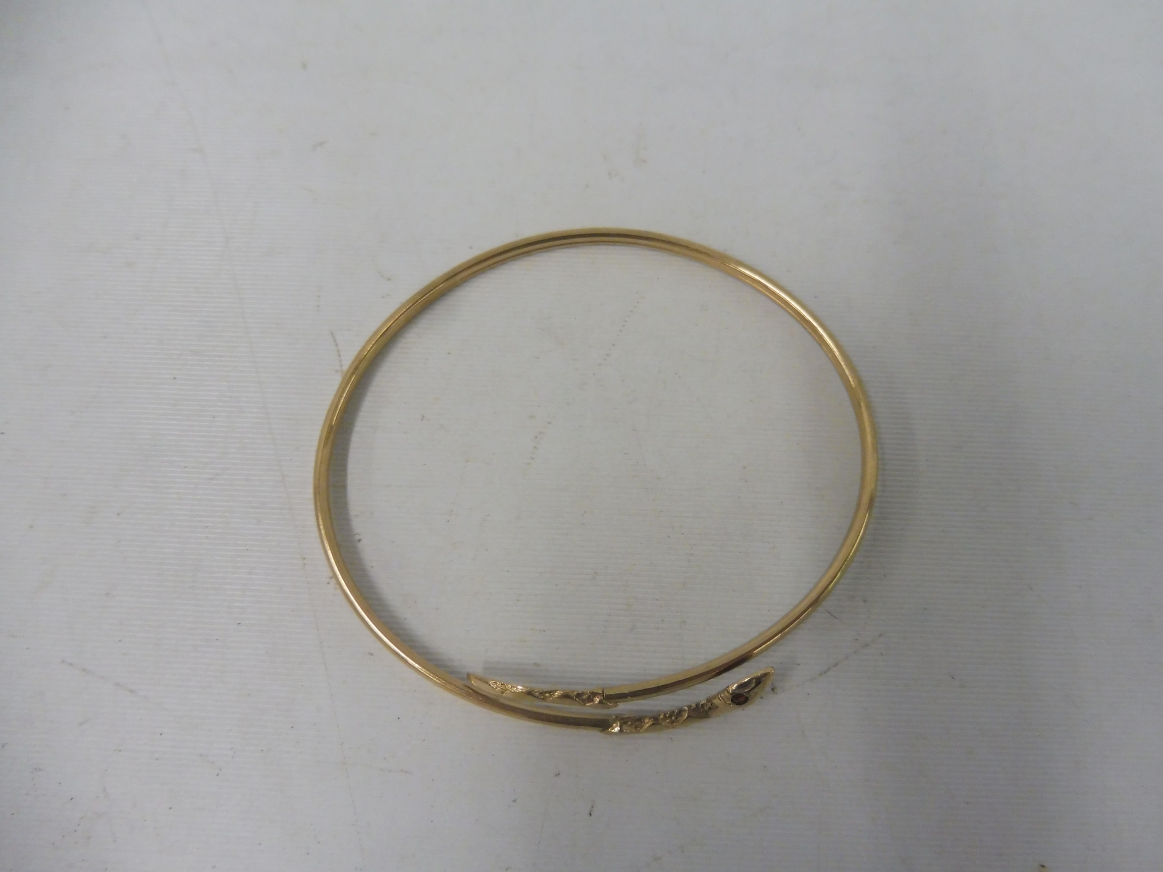 A 9ct gold snake bangle set with rubies, approx. 4.9g. - Image 2 of 2