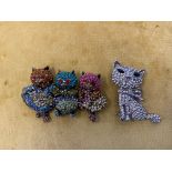 Two Butler & Wilson brooches - Happy Cats, w 6.5cm and a crystal cat with bow around neck, h 4.