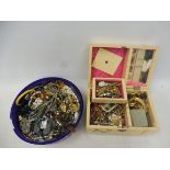 A wooden box containing a good selection of a lifetime's worth of jewellery accompanied by a tub