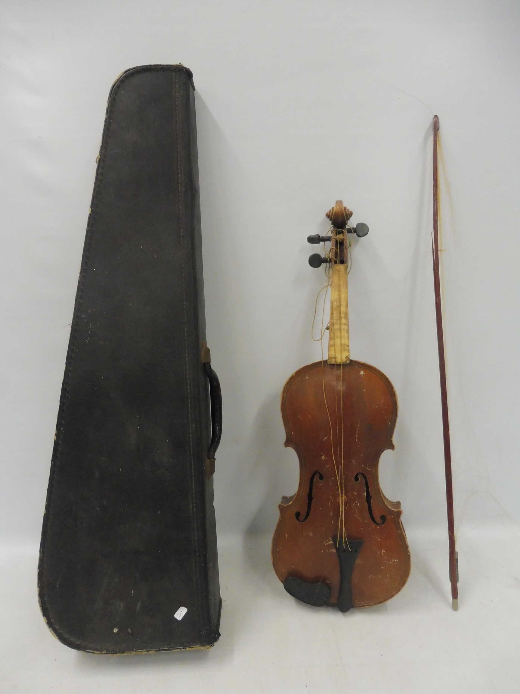 A cased old violin and bow for restoration.