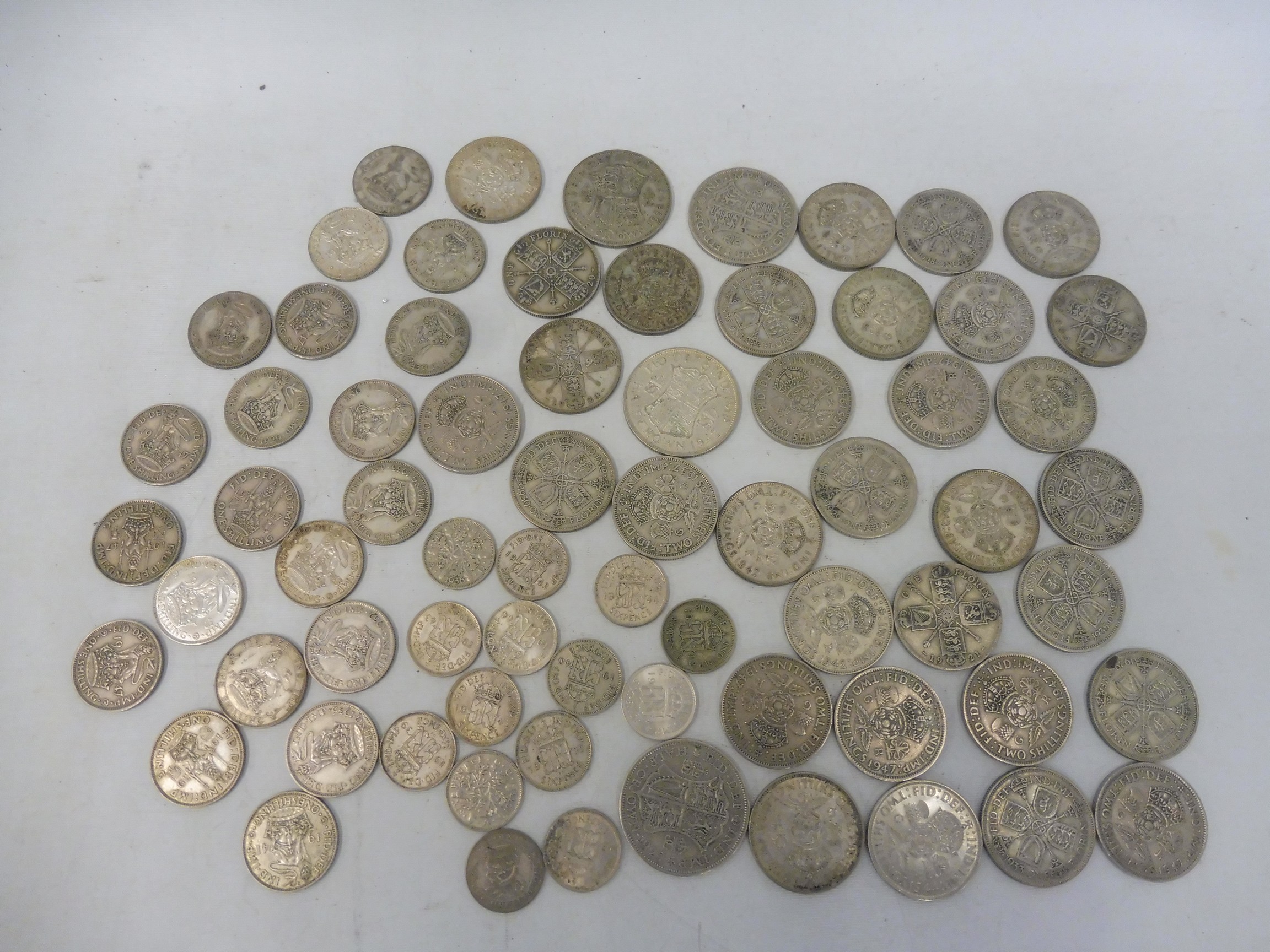 A selection of pre-1948 English silver coins including shillings, florins and crowns, approx. 567.6g