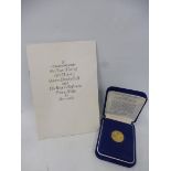 A cased 1975 100 dollar gold coin of Bermuda, with certificate of authenticity and accompanying