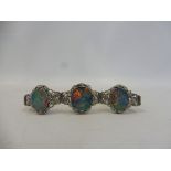 A 9ct white gold bracelet set with three fire opals bearing inscription to clasp, with safety chain,