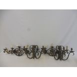 Two pairs of wrought iron wall lights.